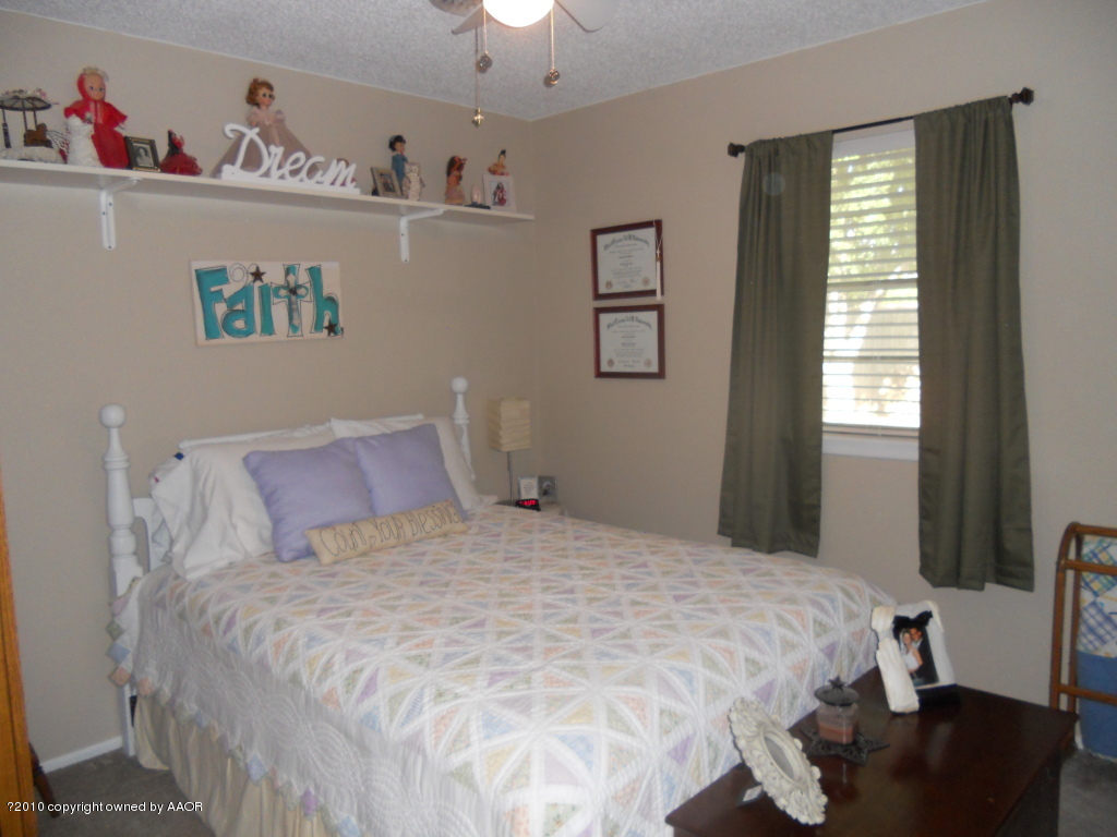 5117 McCarty Boulevard Amarillo, TX 79110 - Photo 12 of 17 a bedroom with a bed and a window