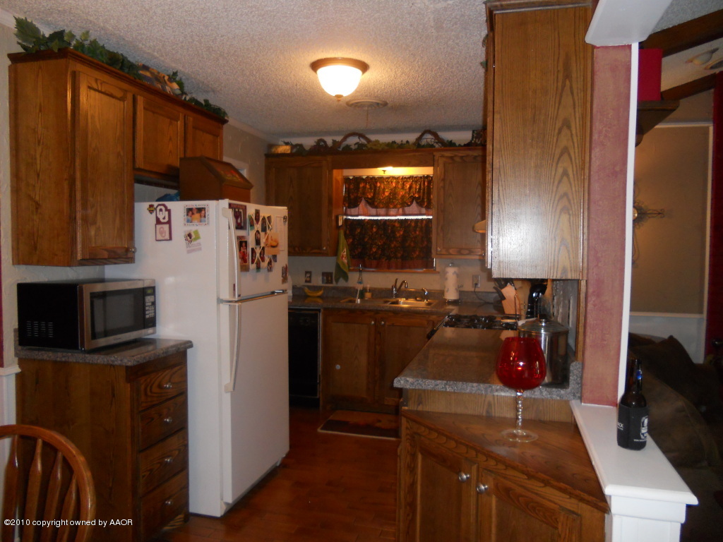 5117 McCarty Boulevard Amarillo, TX 79110 - Photo 5 of 17 a kitchen with a refrigerator stove and microwave
