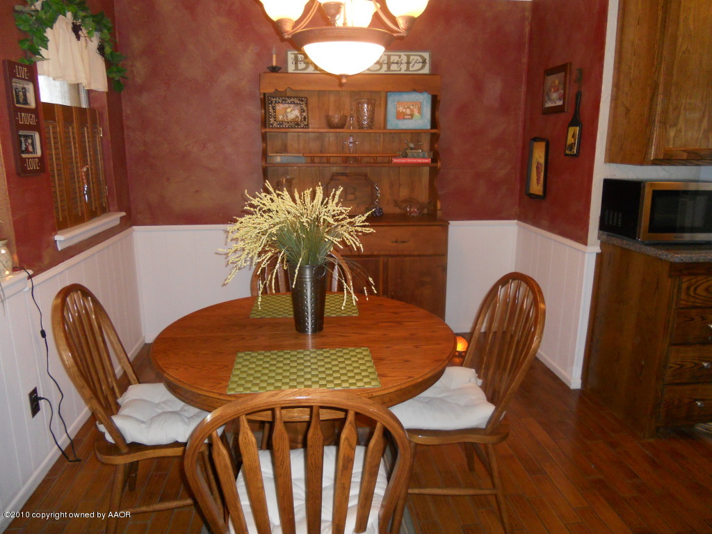 5117 McCarty Boulevard Amarillo, TX 79110 - Photo 7 of 17 a dining room with furniture and wooden floor