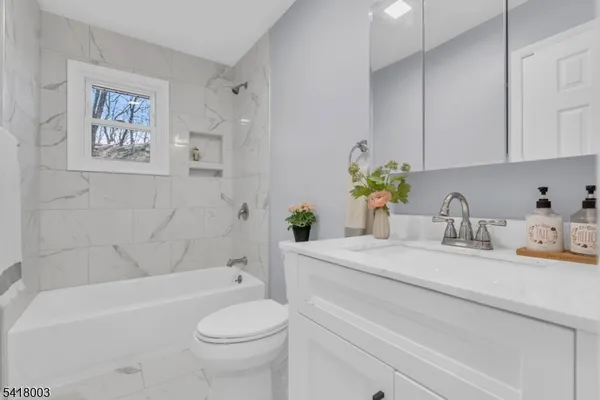 a bathroom with a sink a toilet and bathtub