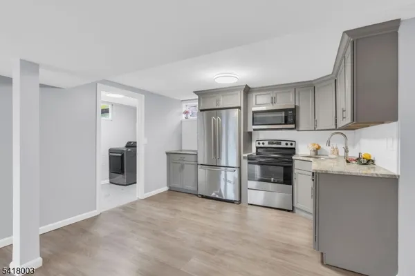 a kitchen with stainless steel appliances a refrigerator stove microwave and sink