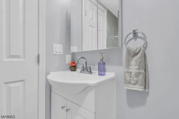 a bathroom with a sink vanity and a mirror