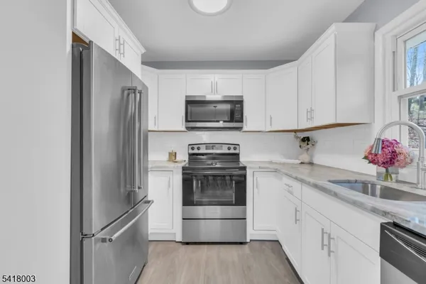 a kitchen with a sink and steel appliances