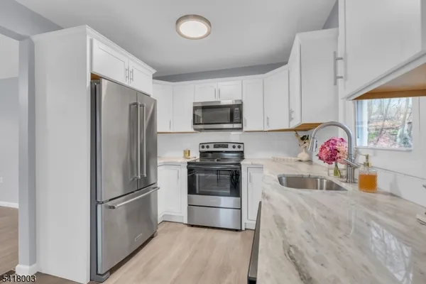 a kitchen with a refrigerator sink and microwave