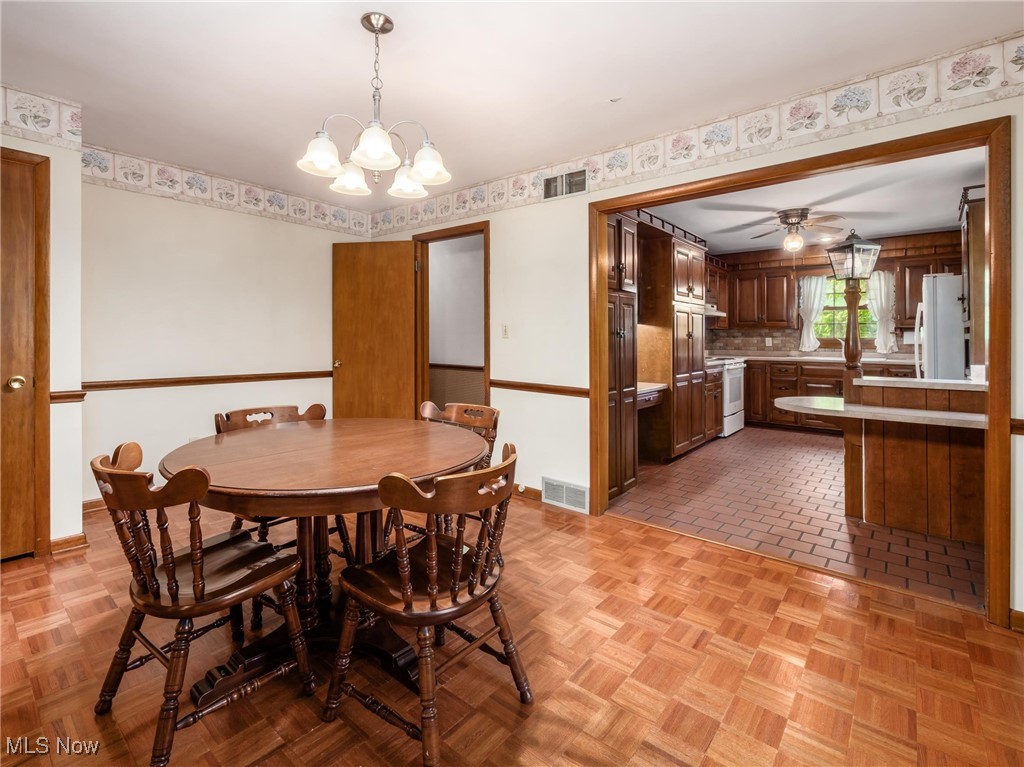 975 Richey Road Zanesville, OH 43701 - Photo 6 of 27 Dining area featuring a chandelier, baseboards, and a ceiling fan