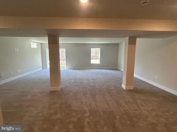 a view of a big room with closet and windows