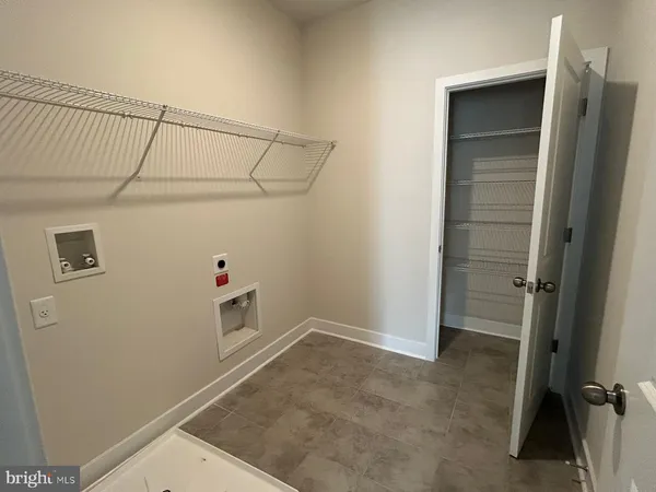 a view of storage and utility room with closet