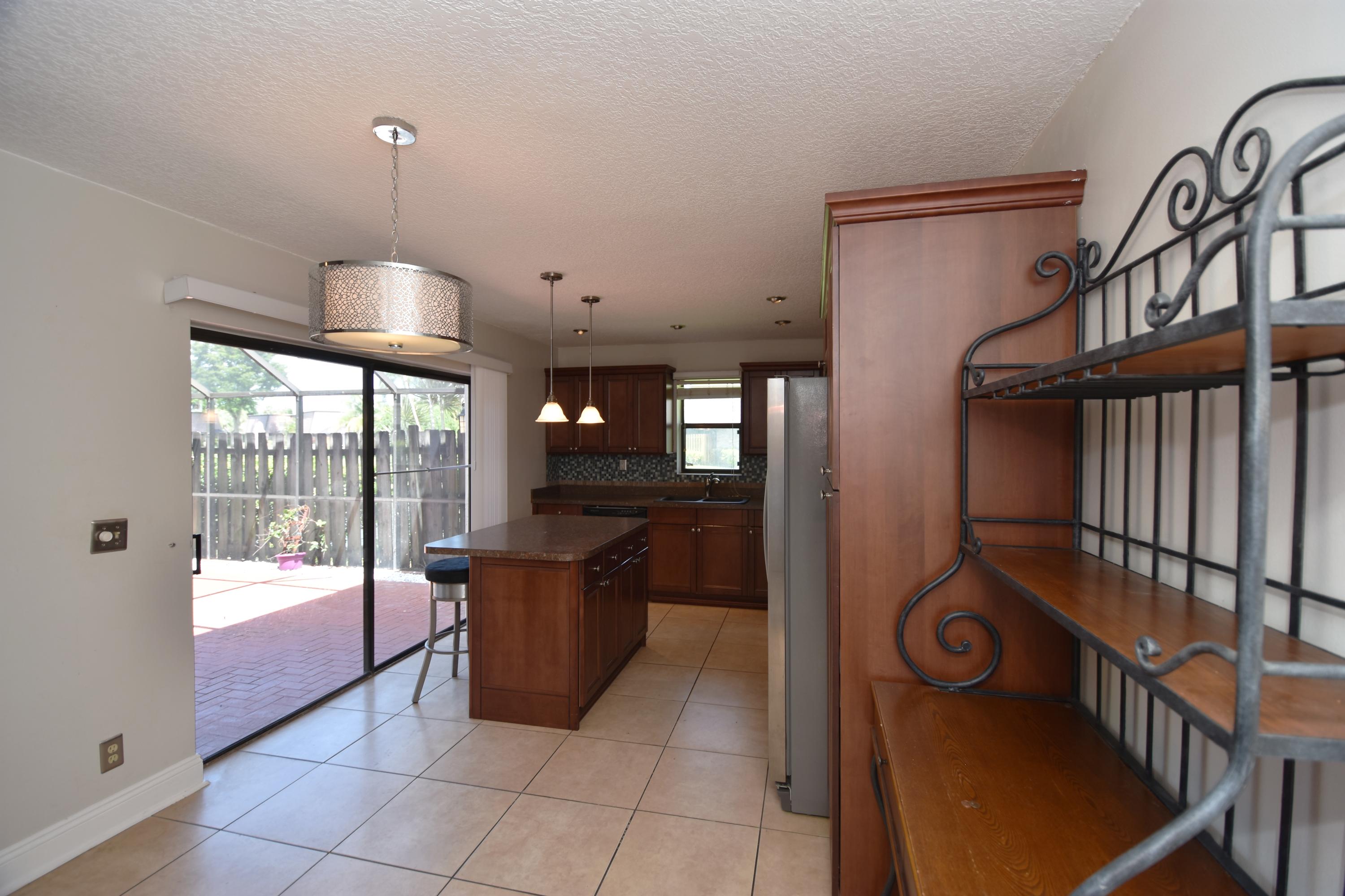 7687 Courtyard Run West Boca Raton, FL 33433 - Photo 10 of 27 Kitchen to patio