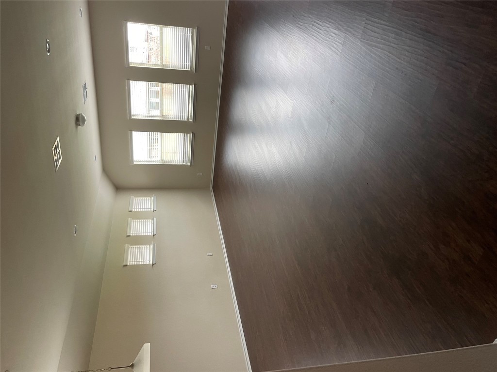 3473 Pauling Loop Round Rock, TX 78665 - Photo 13 of 26 an empty room with wooden floor and windows