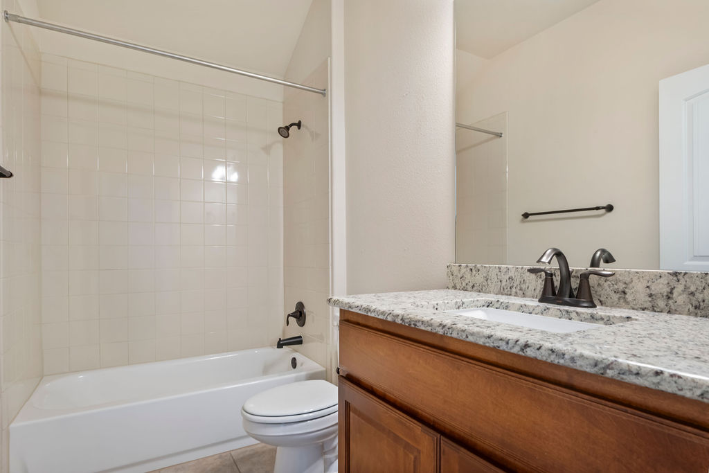 3473 Pauling Loop Round Rock, TX 78665 - Photo 15 of 33 a bathroom with a granite countertop sink toilet and shower