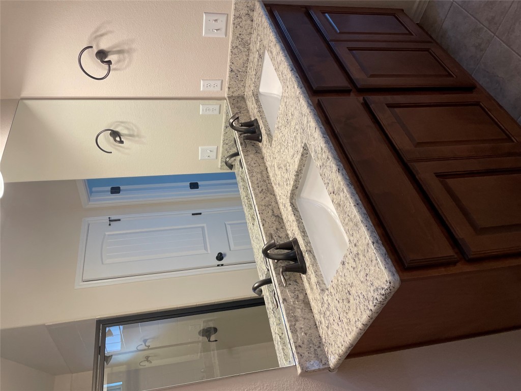 3473 Pauling Loop Round Rock, TX 78665 - Photo 18 of 26 a bathroom with a granite countertop sink and a mirror