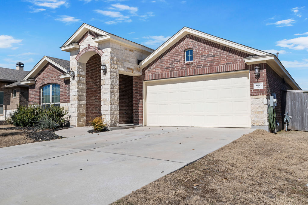 3473 Pauling Loop Round Rock, TX 78665 - Photo 2 of 33 a front view of a house with a yard