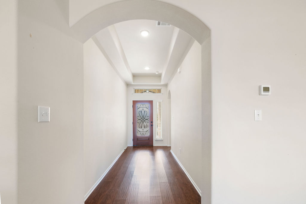 3473 Pauling Loop Round Rock, TX 78665 - Photo 22 of 33 a view of a hallway with wooden floor