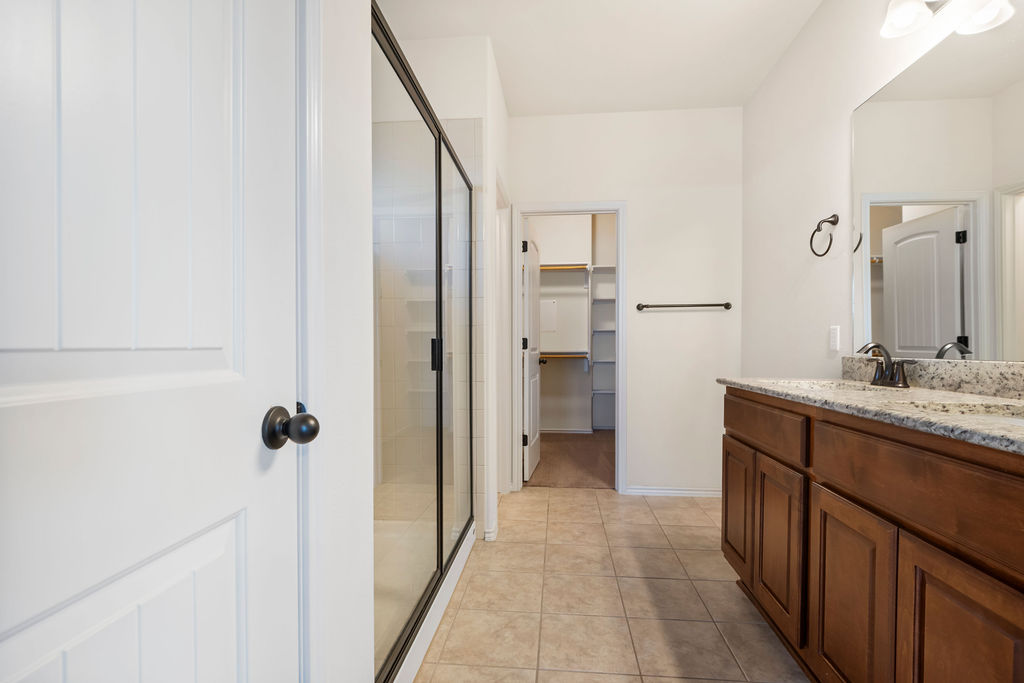 3473 Pauling Loop Round Rock, TX 78665 - Photo 26 of 33 a bathroom with a granite countertop sink mirror and shower