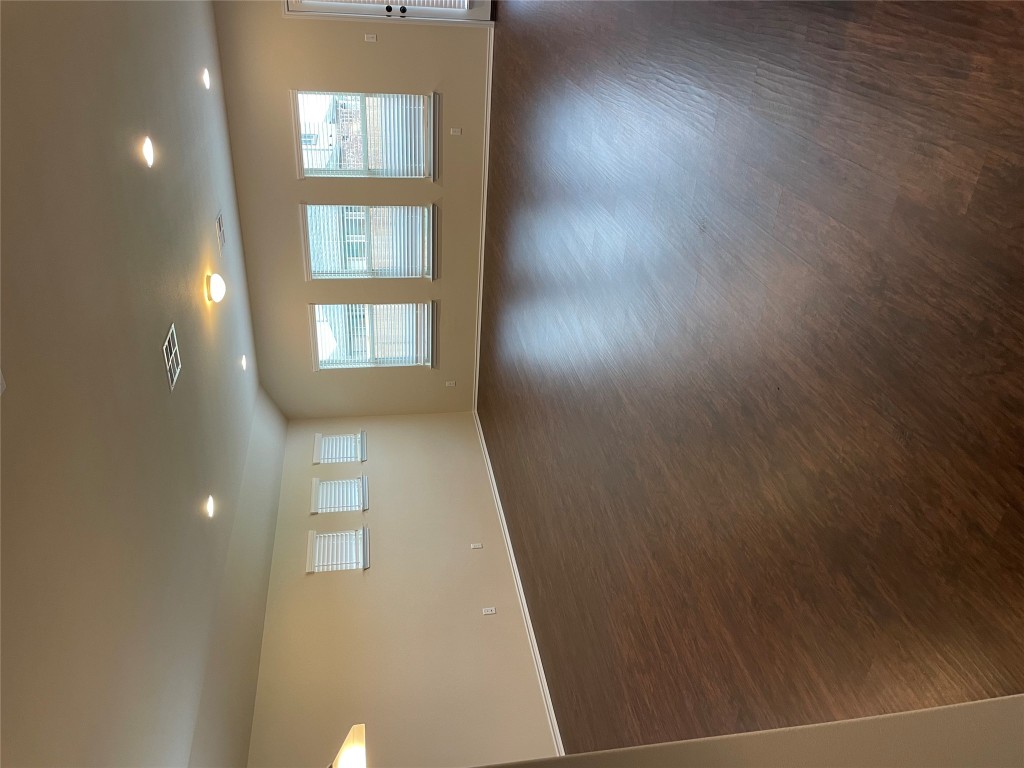 3473 Pauling Loop Round Rock, TX 78665 - Photo 5 of 26 an empty room with wooden floor and windows