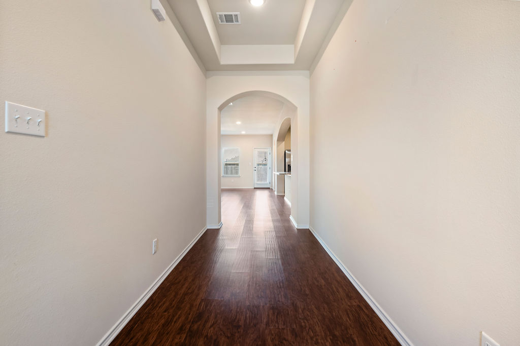 3473 Pauling Loop Round Rock, TX 78665 - Photo 5 of 33 a view of a hallway with wooden floor