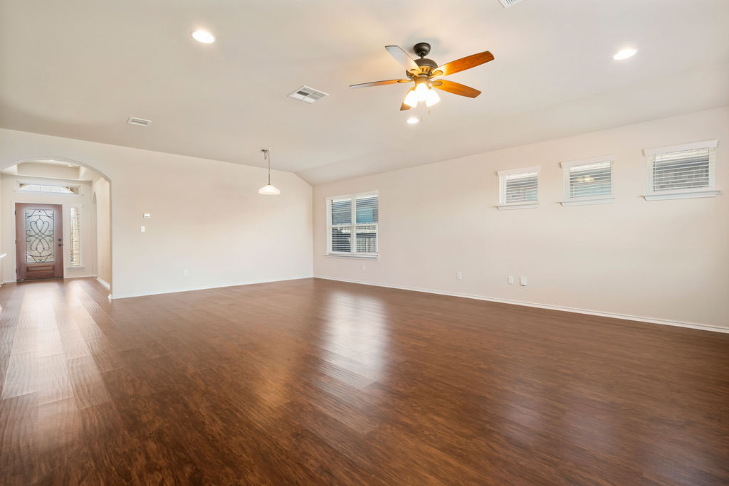 3473 Pauling Loop Round Rock, TX 78665 - Photo 6 of 33 an empty room with wooden floor and windows