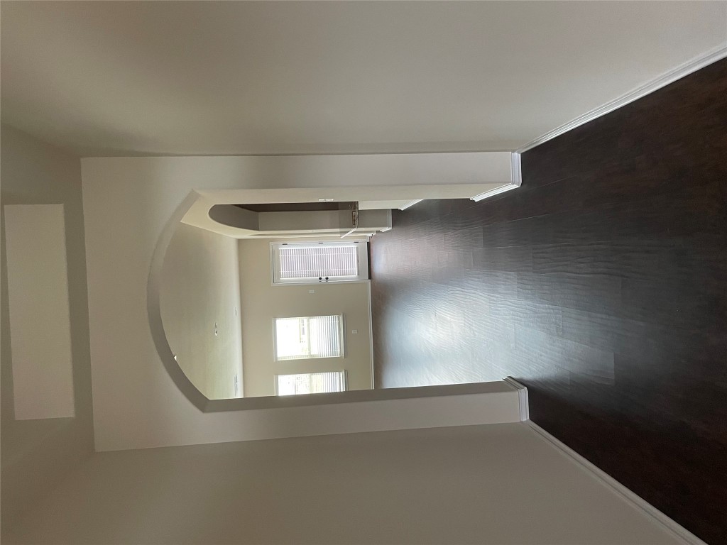 3473 Pauling Loop Round Rock, TX 78665 - Photo 6 of 26 a view of a hallway with wooden floor and a cabinet