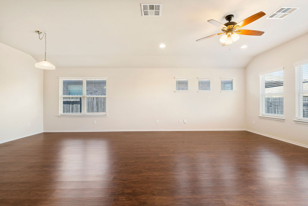 3473 Pauling Loop Round Rock, TX 78665 - Photo 9 of 33 a view of an empty room with window and wooden floor