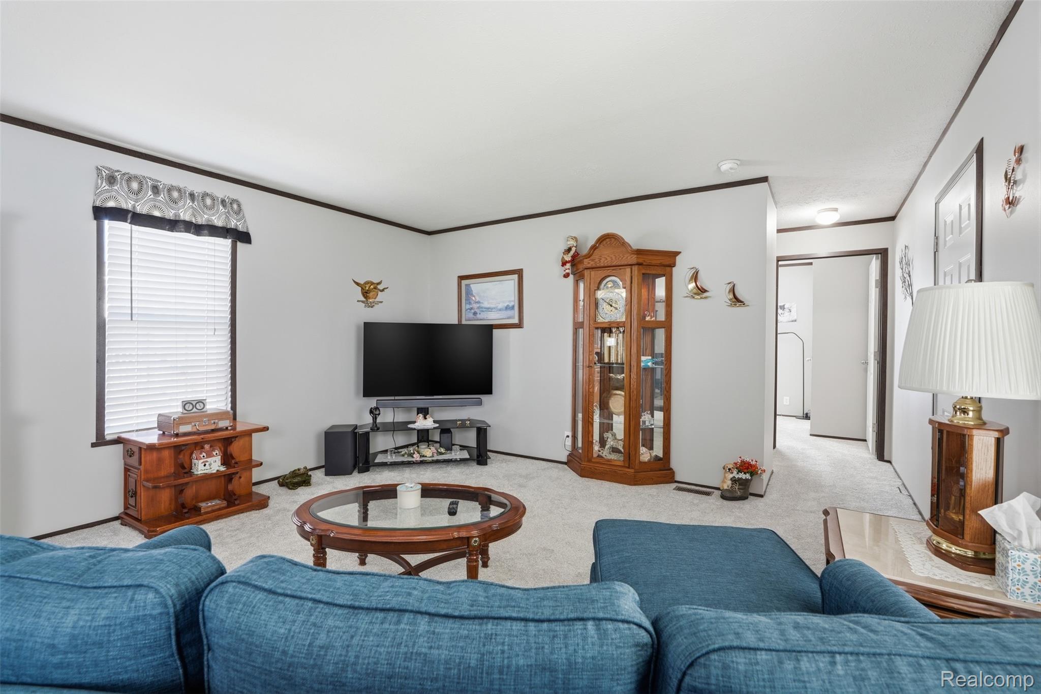 440 Flamingo Street Rochester, MI 48309 - Photo 12 of 32 Carpeted living room featuring ornamental molding