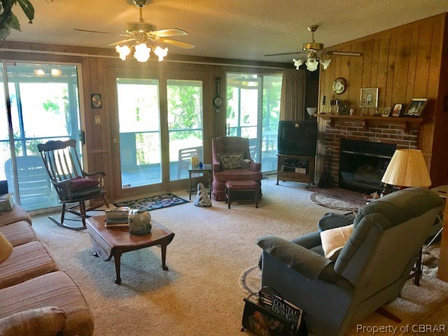 624 Moores Pointe Road Deltaville, VA 23043 - Photo 10 of 15 Living room with double doors going out to the patio. Bank of doors and window for the ultimate view.