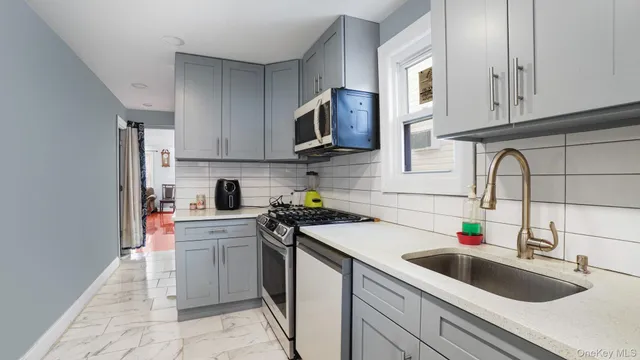 a kitchen with stainless steel appliances granite countertop a sink dishwasher stove and oven with cabinets