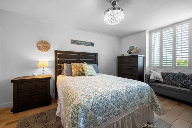 a bedroom with a bed and a chandelier