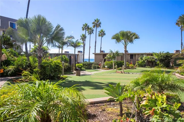 a view of a swimming pool with a garden and trees