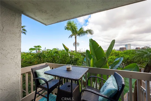 a vase of flowers sitting on a table with chairs