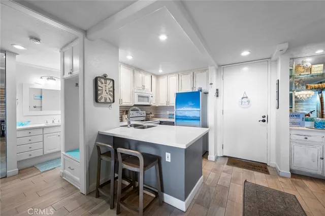 a kitchen with a table chairs and refrigerator