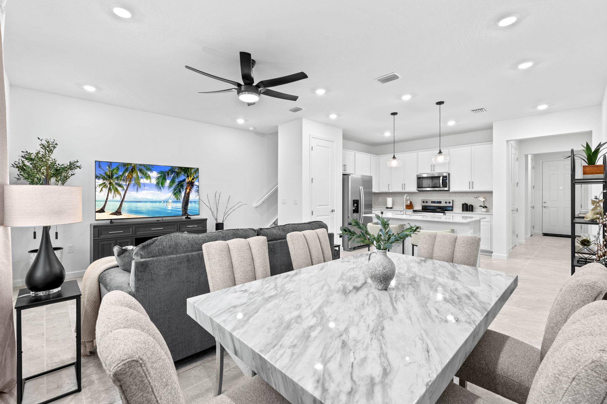 a living room with furniture and kitchen view
