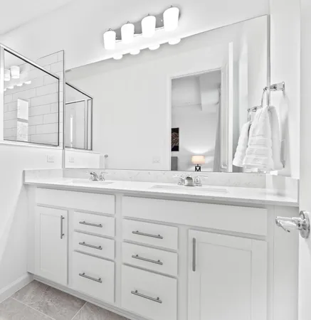 a bathroom with a sink vanity and mirror