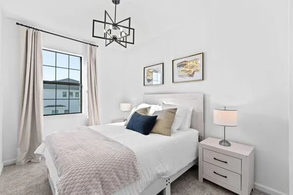 a bedroom with a bed and a night stand