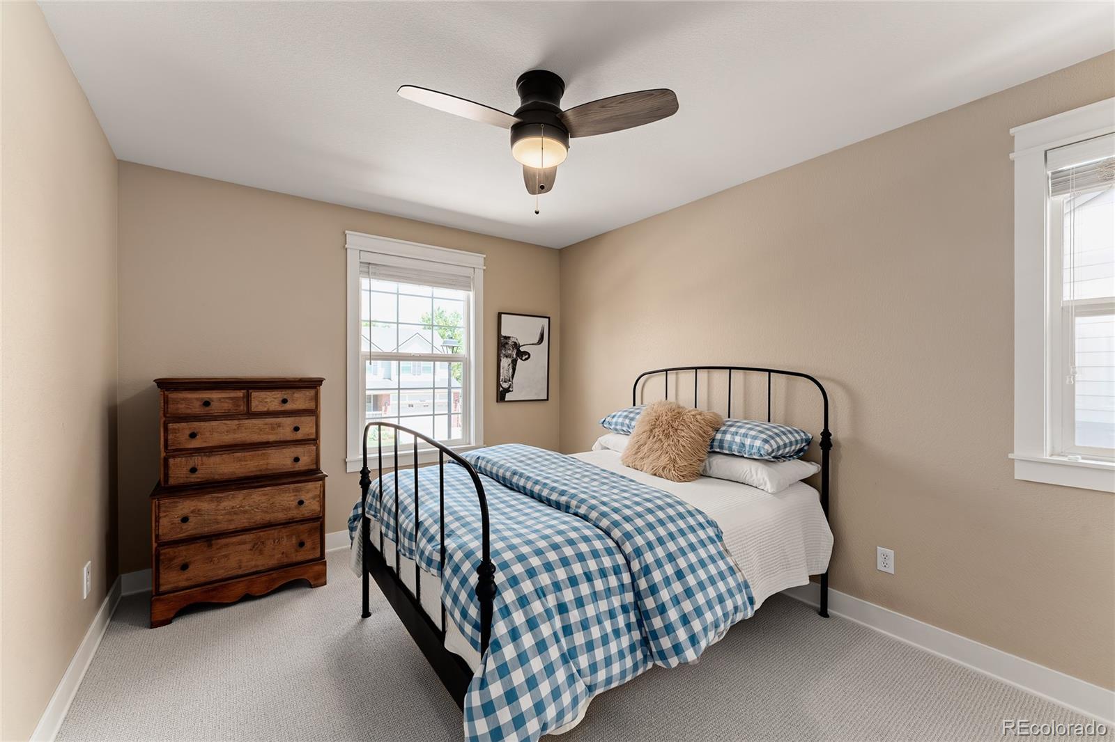 9441 South Hackberry Lane Highlands Ranch, CO 80129 - Photo 34 of 50 a bedroom with a bed chandelier and a window
