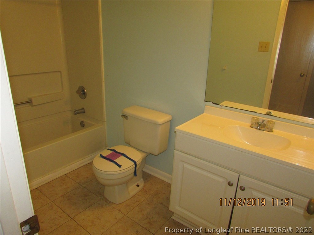 947 Rim Road Fayetteville, NC 28314 - Photo 8 of 10 a bathroom with a granite countertop toilet and a sink