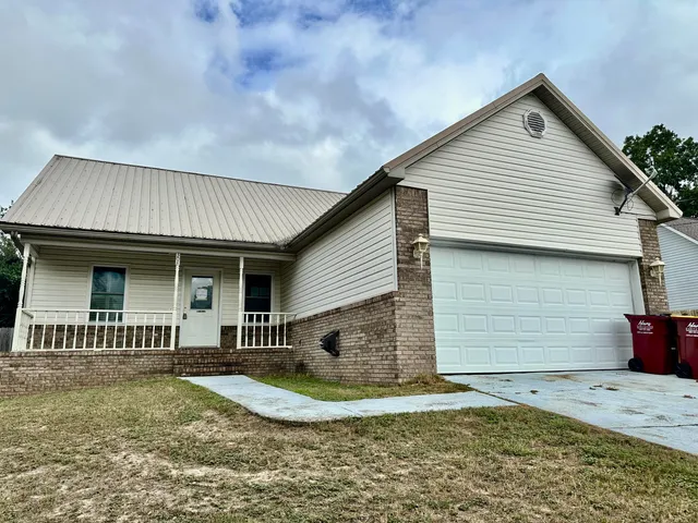 a front view of a house with garden