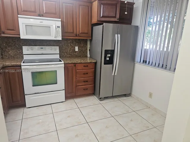 a kitchen with a stove top oven and cabinets