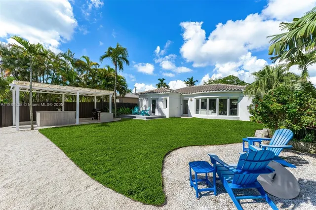 a view of a house with a yard and furniture