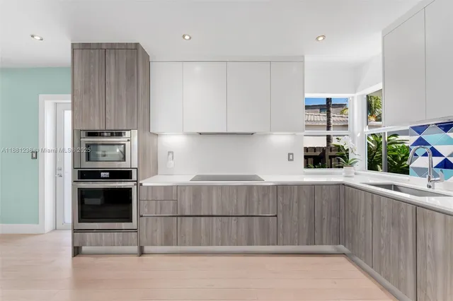 a kitchen with kitchen island granite countertop a stove and a refrigerator