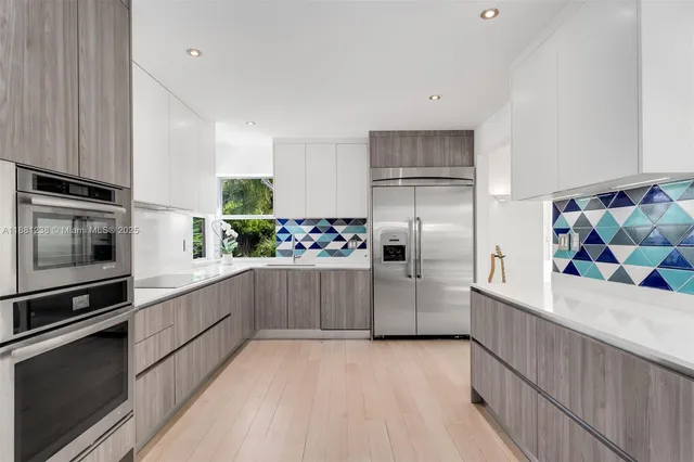 a kitchen with stainless steel appliances a refrigerator and a stove top oven