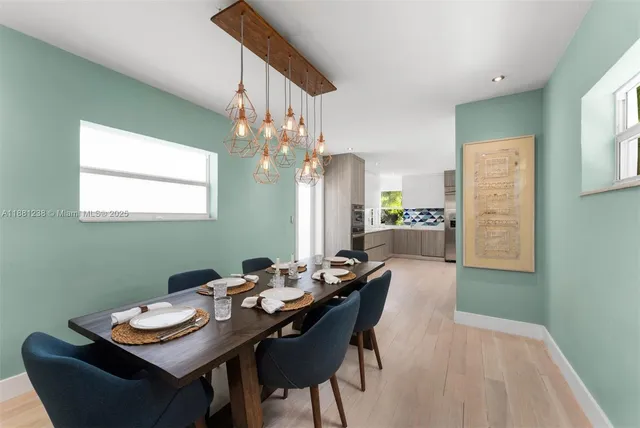 a view of a dining room with furniture and a chandelier