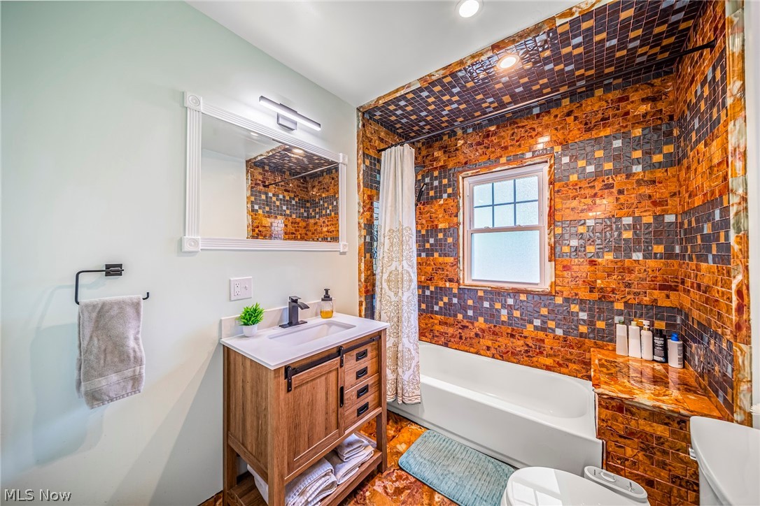 2504 Lee Road Cleveland, OH 44118 - Photo 23 of 41 Full bathroom featuring a tiled shower / bath combination, vanity, and toilet
