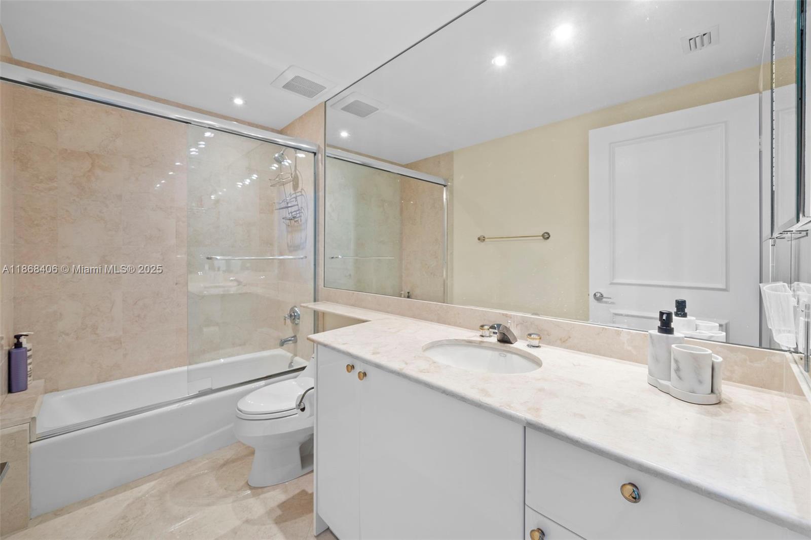 781 Crandon Boulevard, Unit 1802 Key Biscayne, FL 33149 - Photo 19 of 59 a bathroom with a sink a toilet and shower