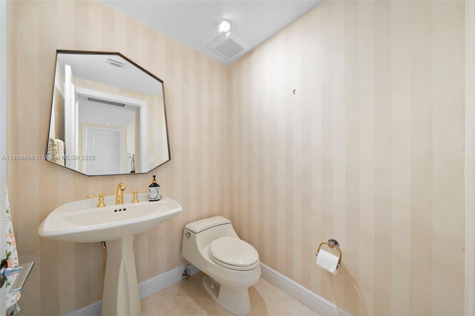 781 Crandon Boulevard, Unit 1802 Key Biscayne, FL 33149 - Photo 26 of 59 a bathroom with a toilet sink and mirror