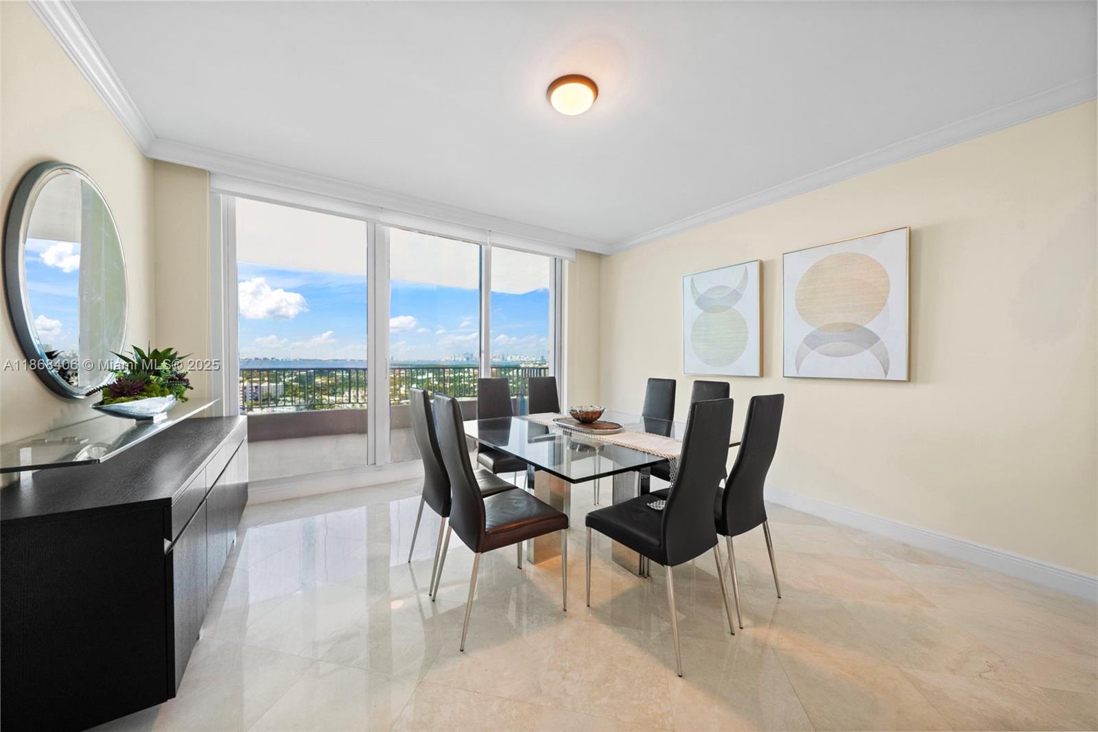 781 Crandon Boulevard, Unit 1802 Key Biscayne, FL 33149 - Photo 9 of 59 a view of a dining room with furniture and a large window