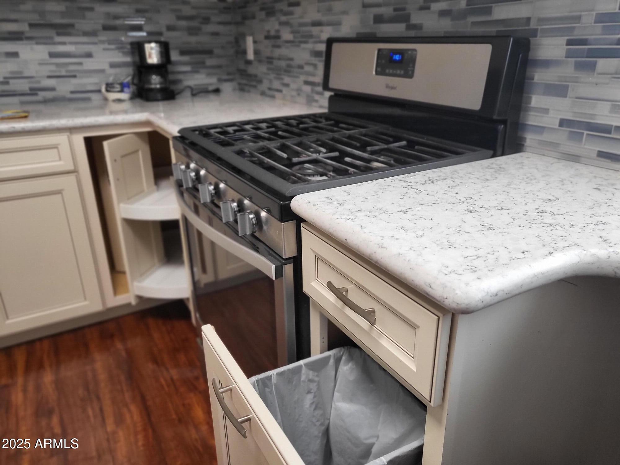 815 North Hayden Road, Unit D207 Scottsdale, AZ 85257 - Photo 11 of 29 a kitchen with a stove and a microwave