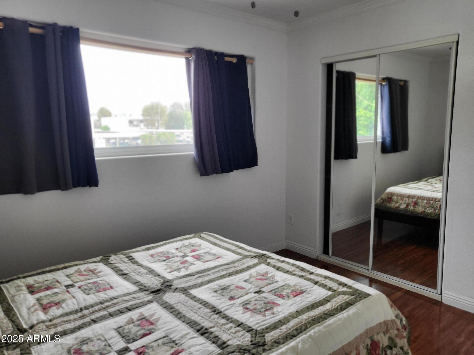 815 North Hayden Road, Unit D207 Scottsdale, AZ 85257 - Photo 20 of 29 a bedroom with a bed and a window