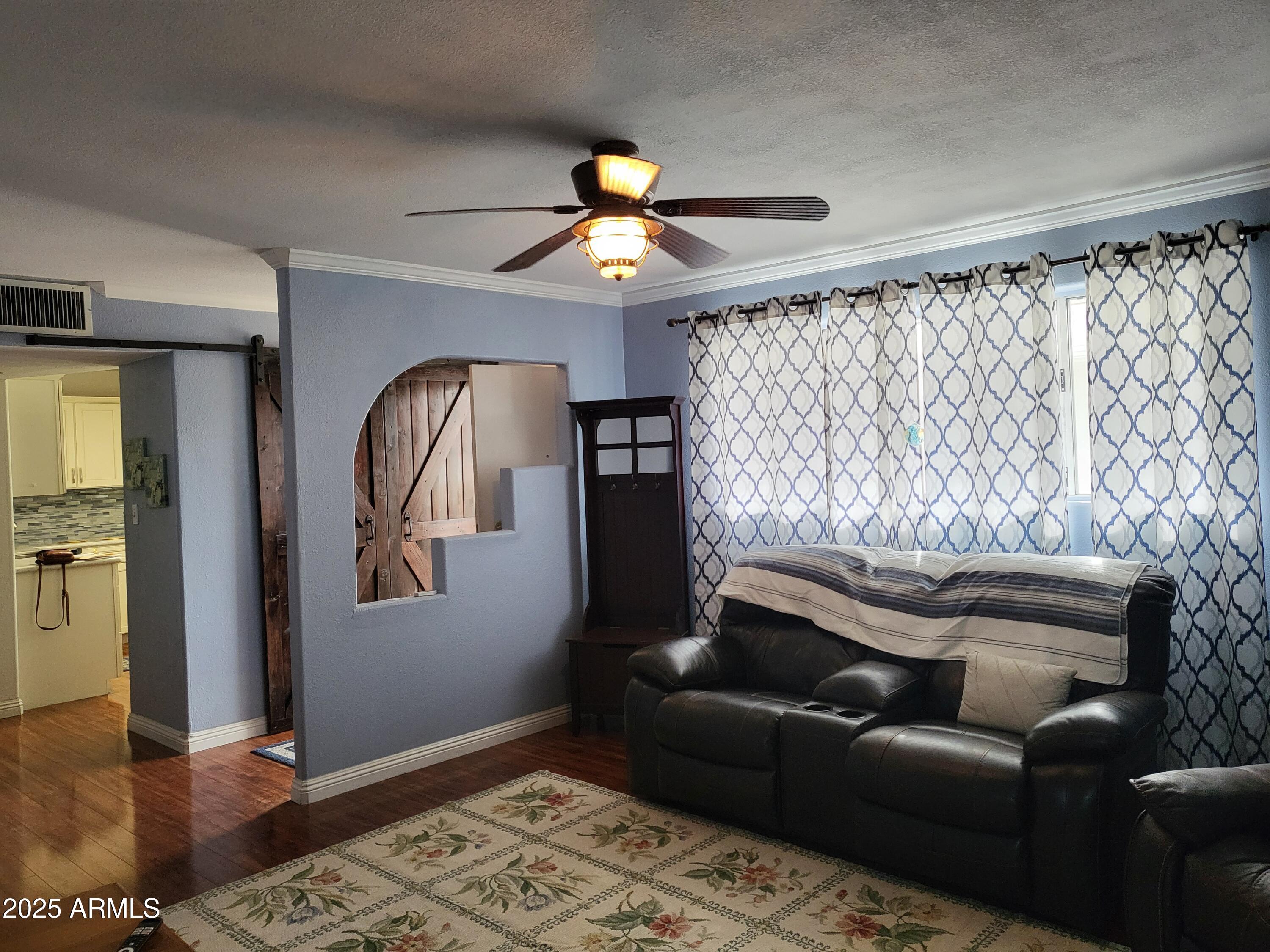 815 North Hayden Road, Unit D207 Scottsdale, AZ 85257 - Photo 2 of 29 a living room with furniture and a chandelier