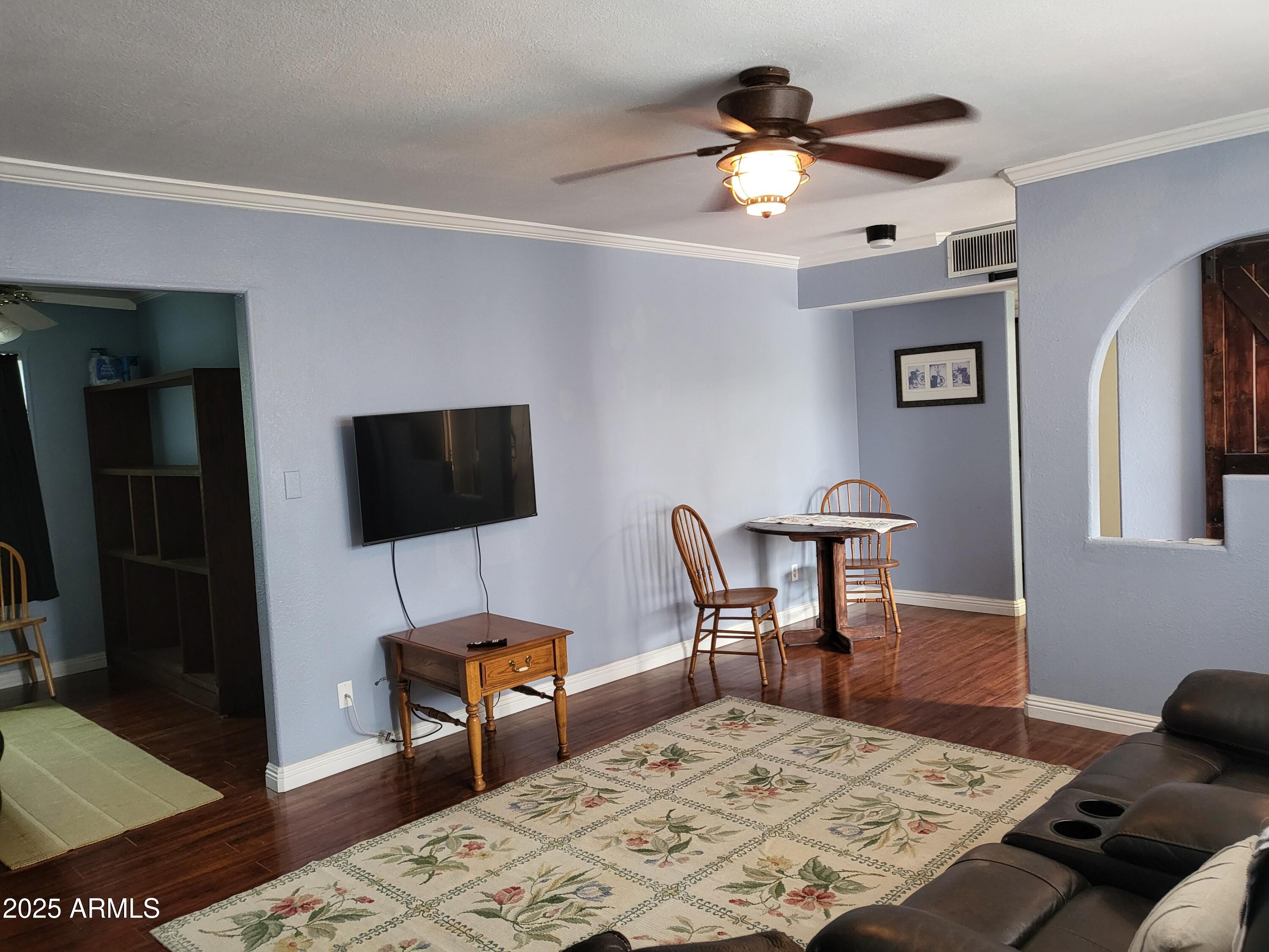 815 North Hayden Road, Unit D207 Scottsdale, AZ 85257 - Photo 6 of 29 a living room with furniture and a flat screen tv