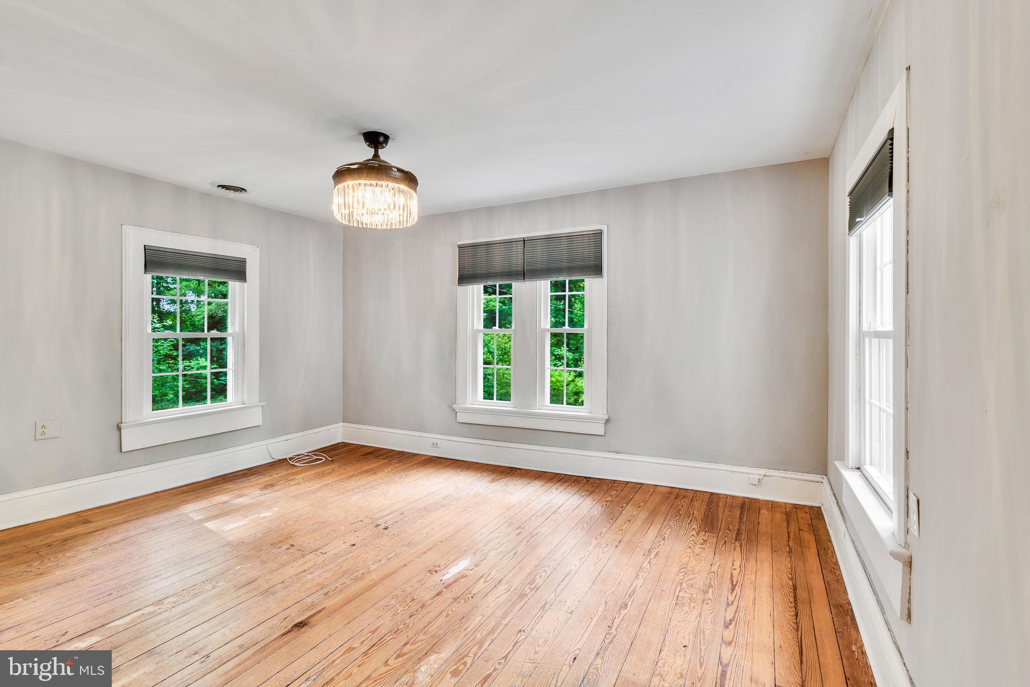 3952 Irvington Road Irvington, VA 22480 - Photo 32 of 77 a view of an empty room with wooden floor and a window